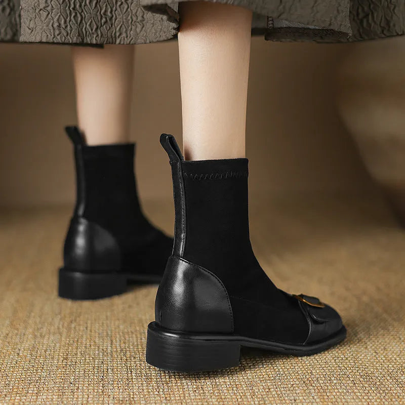 Women's black low heel Martin boots with lace-up front and belt buckle stitching detail on a round toe.