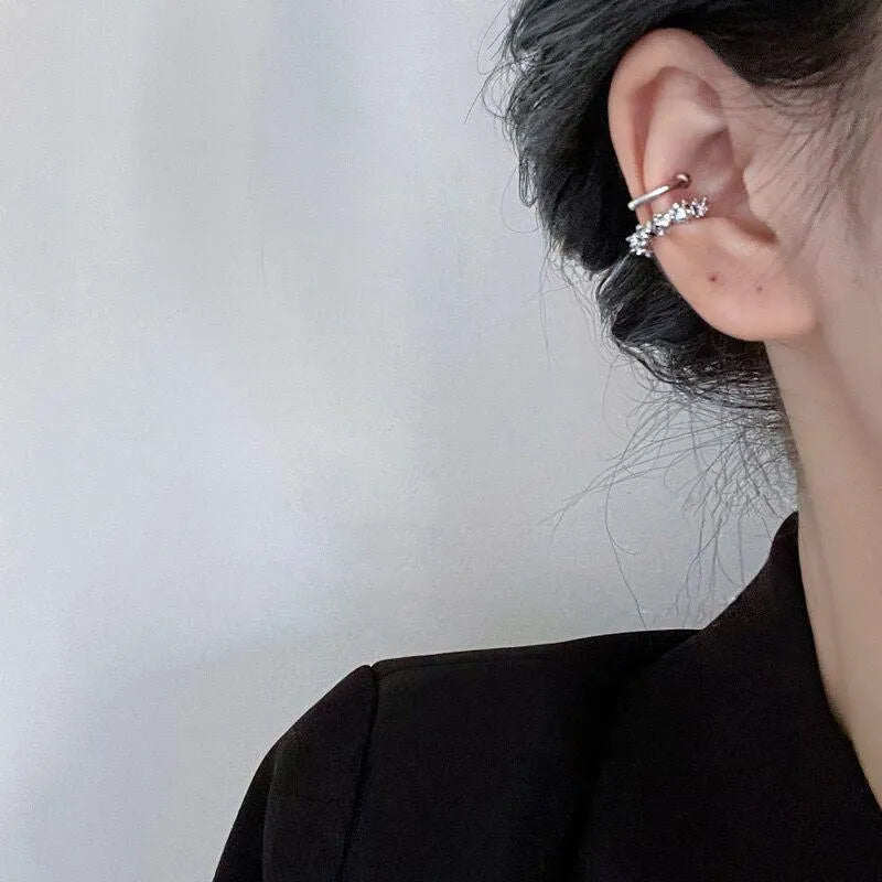 Pair of geometric-shaped alloy ear clips with a frosty finish and double clip mechanism.