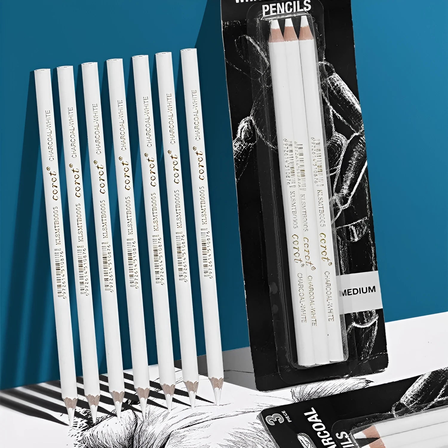 Three white charcoal sketching pencils with wooden casings for highlight work