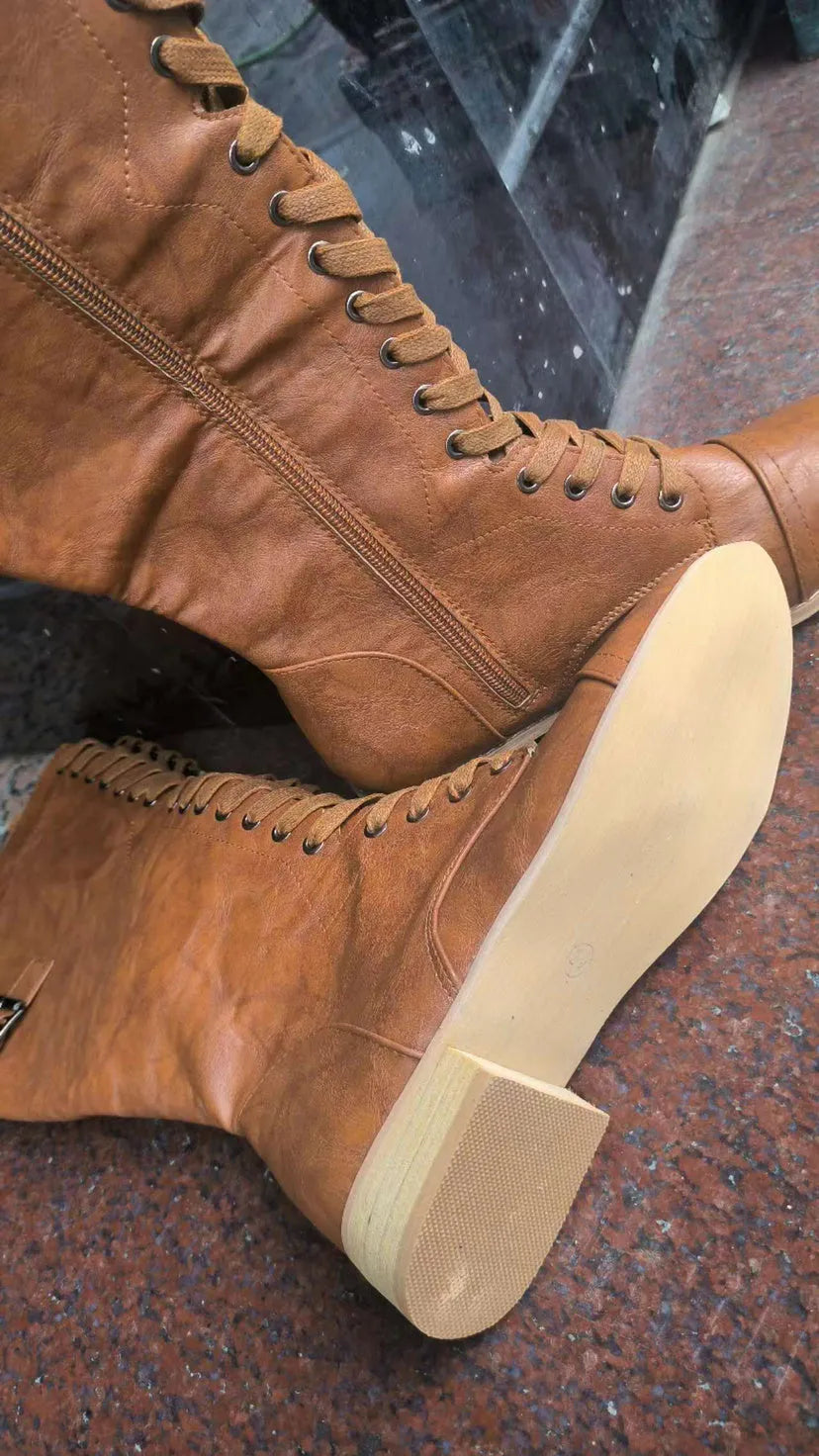 Women's black cross strap knight boots made from artificial PU, showing the ankle strap detail.