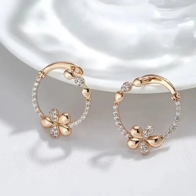 A pair of geometric round ring earrings for women in an electroplated copper finish.