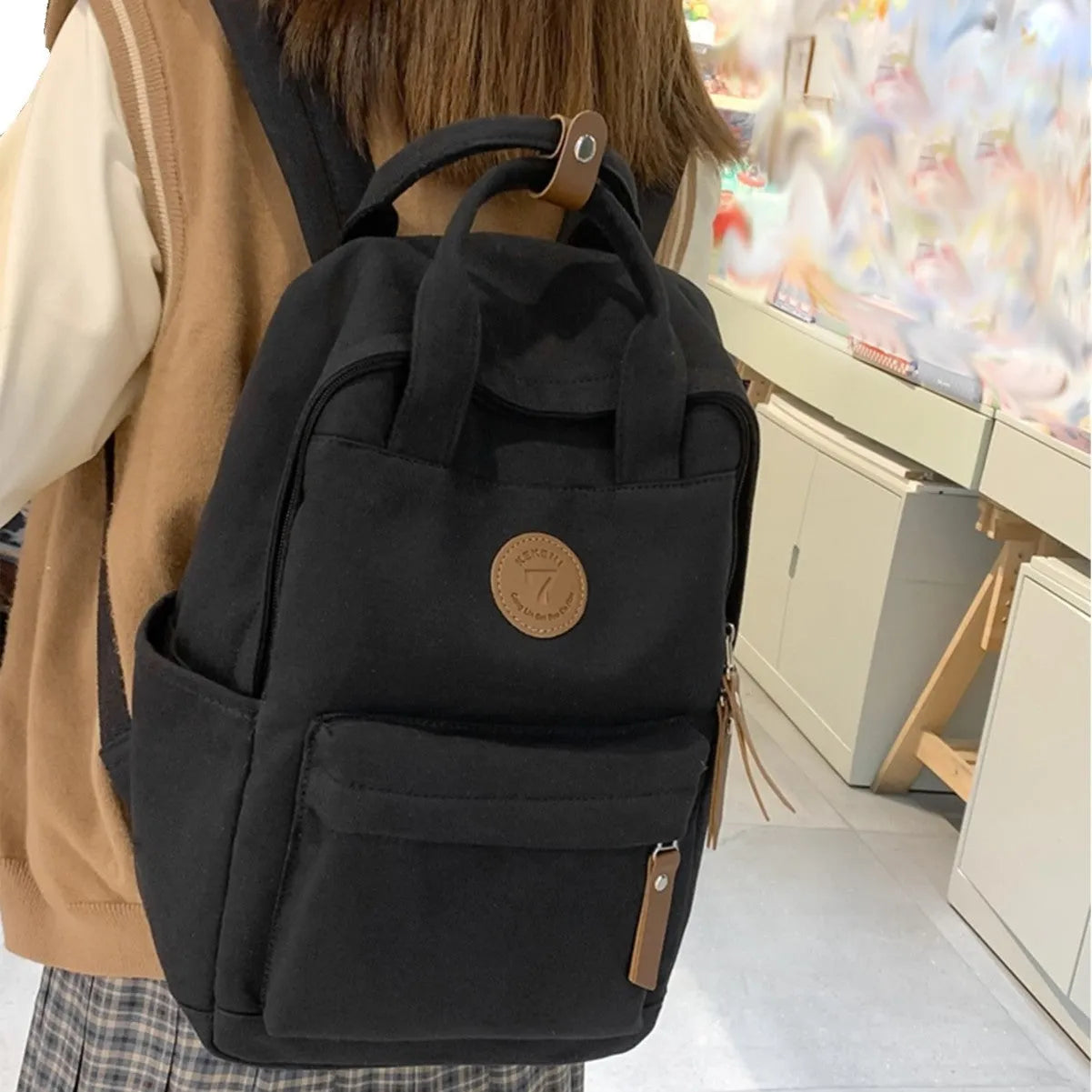 Black Oxford cloth backpack with curved shoulder straps for school and travel