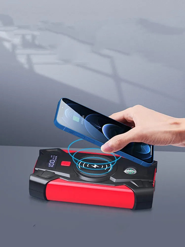 Red car emergency jump starter with digital display and thick battery clips