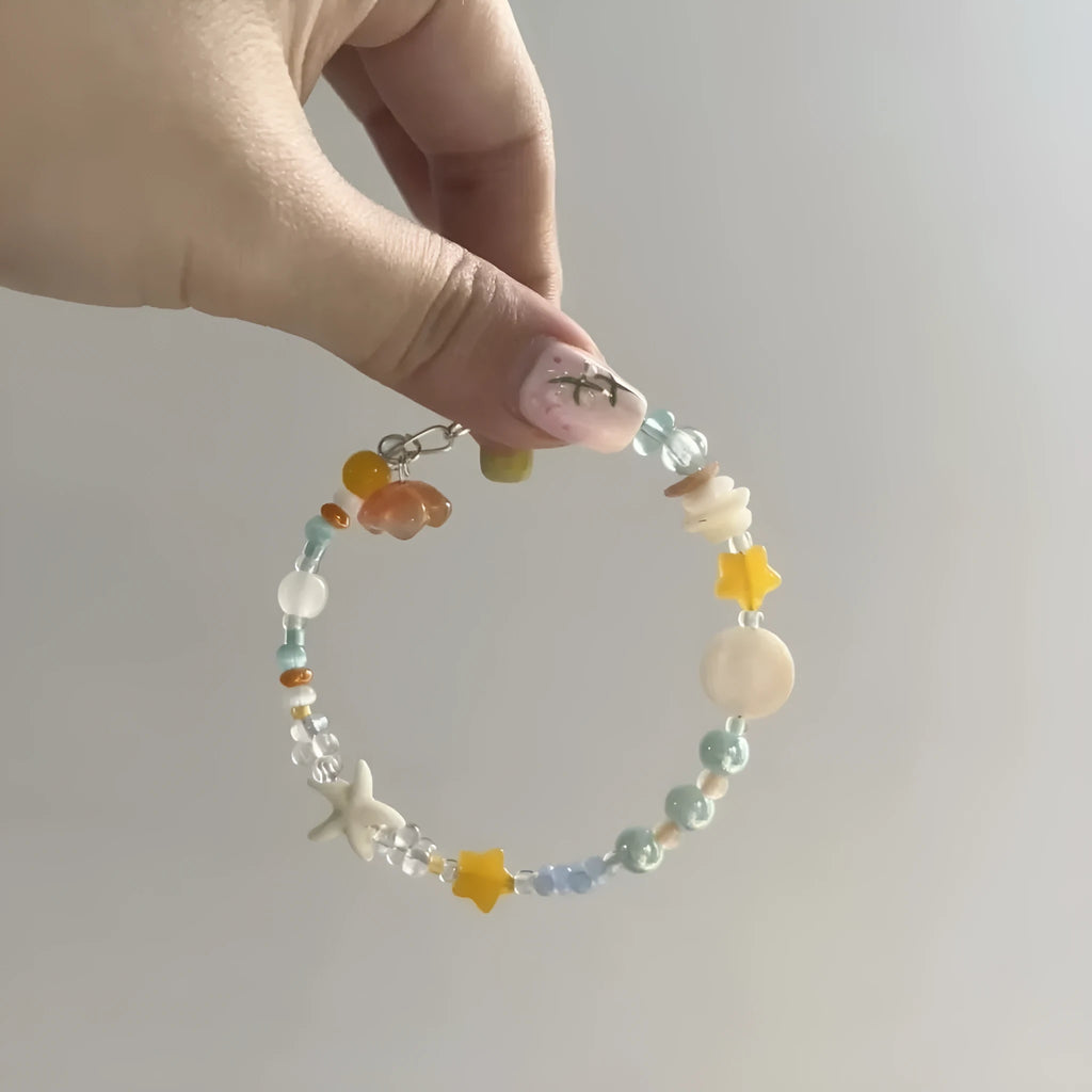 Orange mixed material women's bracelet with diamond shape and round decorative elements