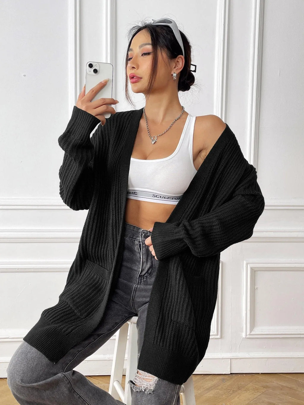 Women's mid-length loose-fit acrylic cardigan in dark green, shown as a single piece with long sleeves.