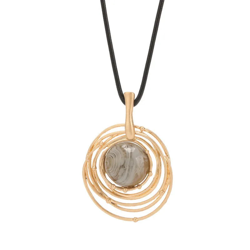 Vintage gold women's necklace with large round plaid pendant on a snake skin chain, shown at adjustable length.