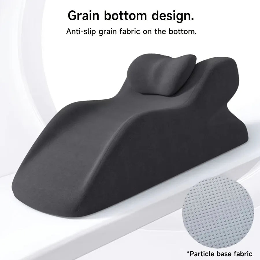A stomach sleeper's pillow in a choice of blue, dark grey, green, or light grey, shown supporting a person lying on their front.