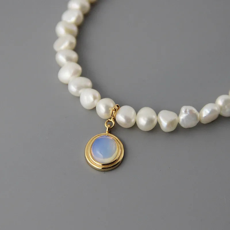 Geometric pearl silver necklace with irregular pearls and adjustable length on white background