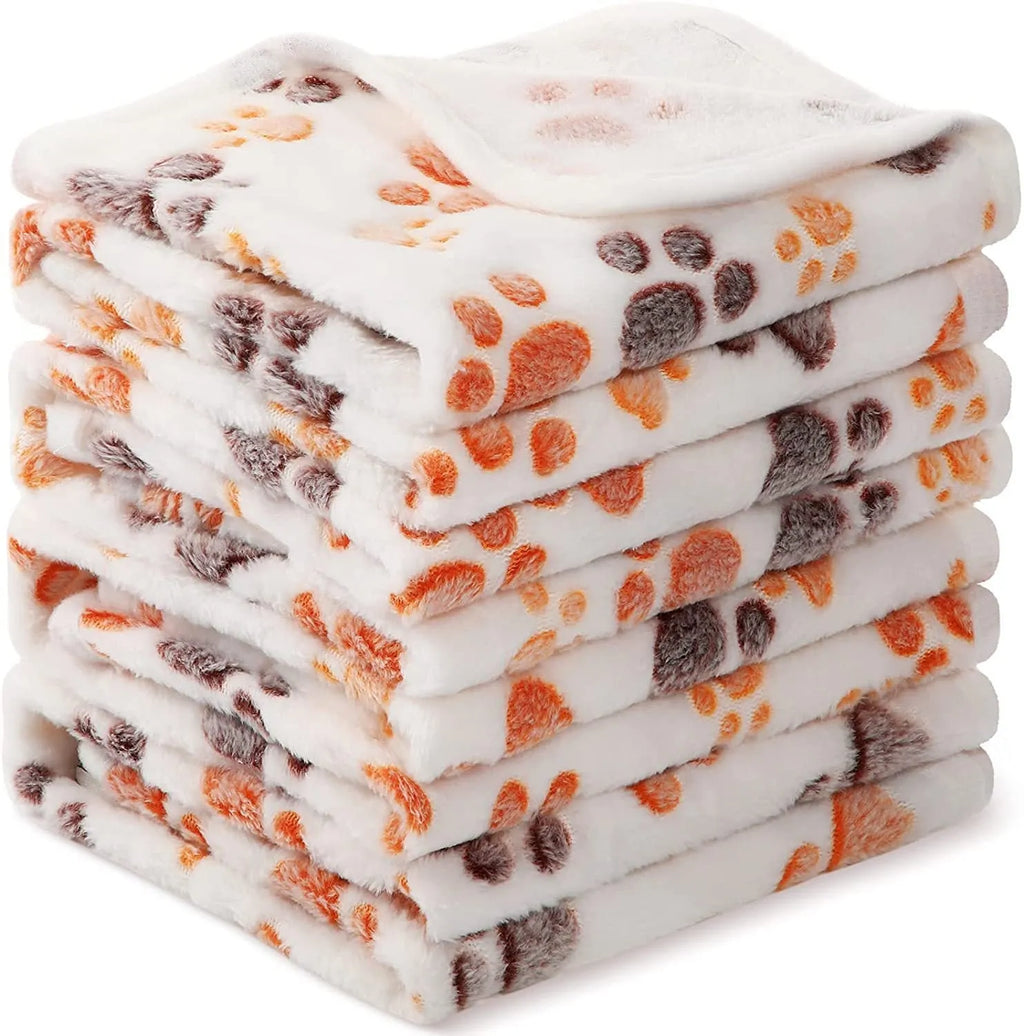 Coral fleece pet blanket with paw print design in beige colour laid flat showing size