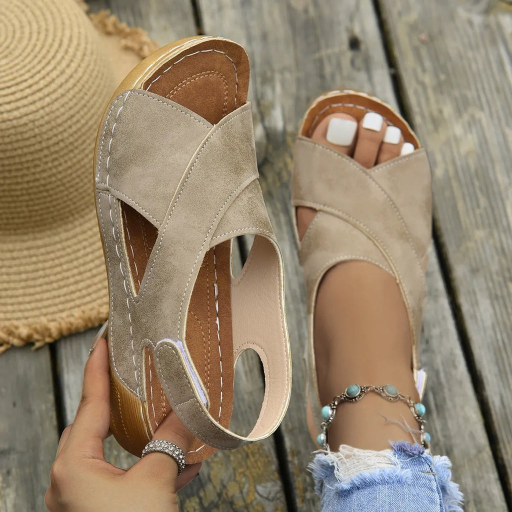 Women's brown platform sandals with a decorative skirt and Velcro strap fastening.