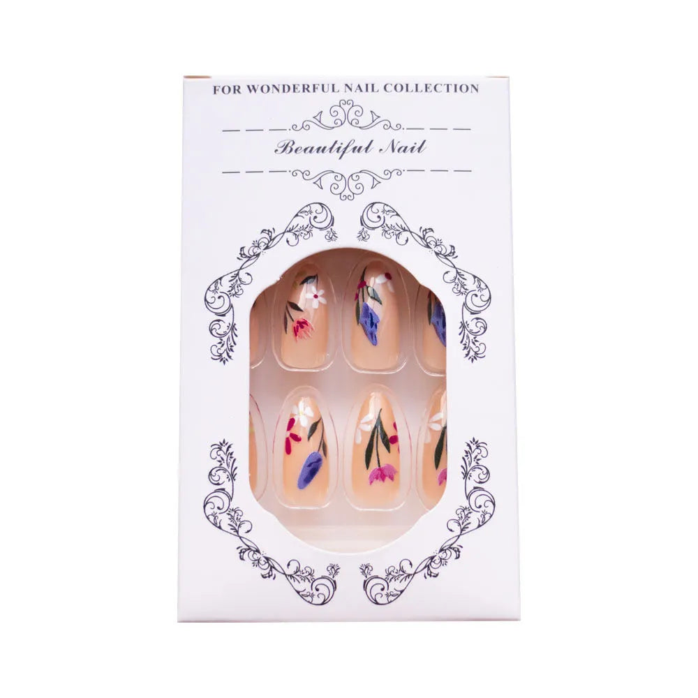 Almond-shaped removable false nails with rose and tulip floral designs on a solid colour background.