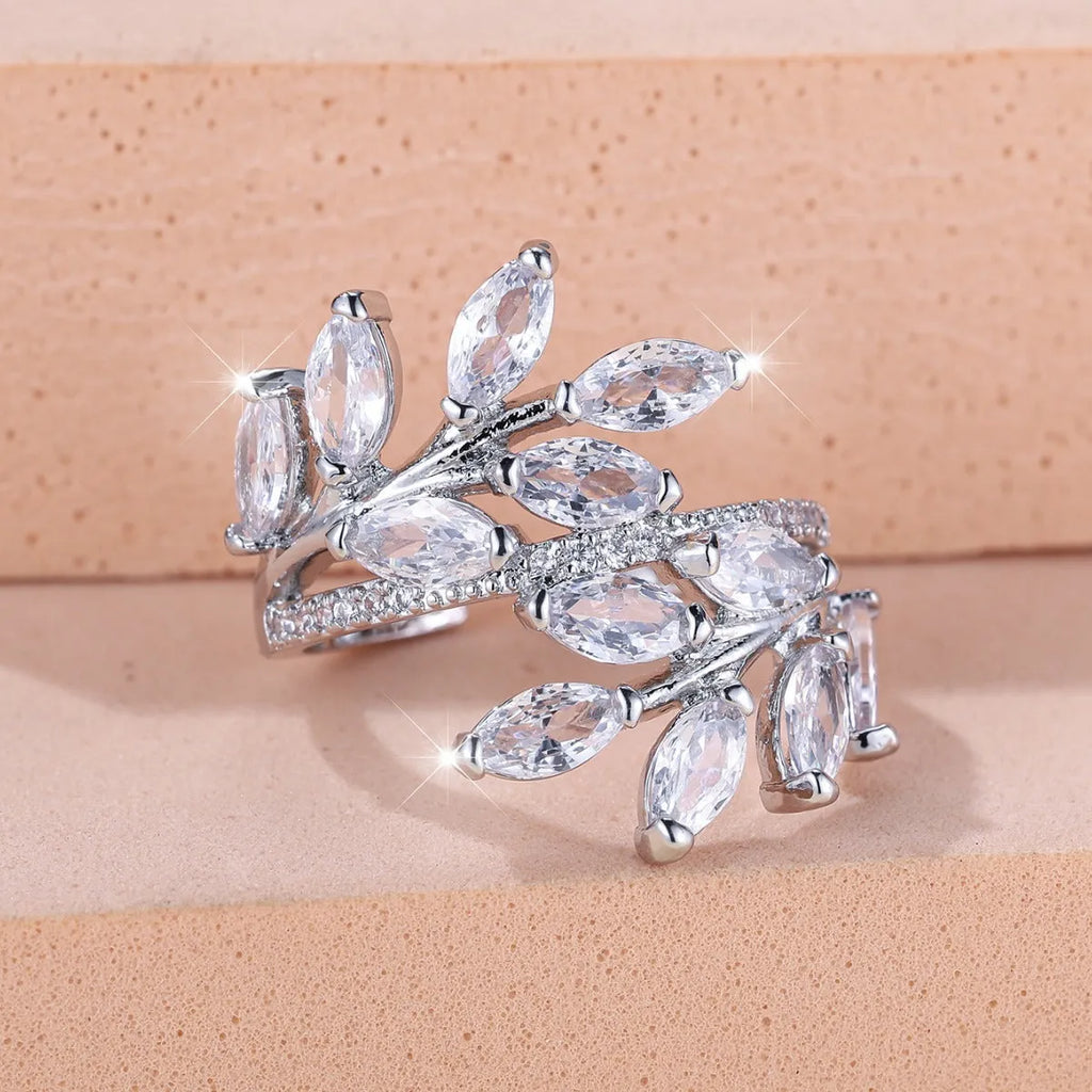 Copper leaf-shaped ring with adjustable band and central horse eye zircon stone in a choice of colours.