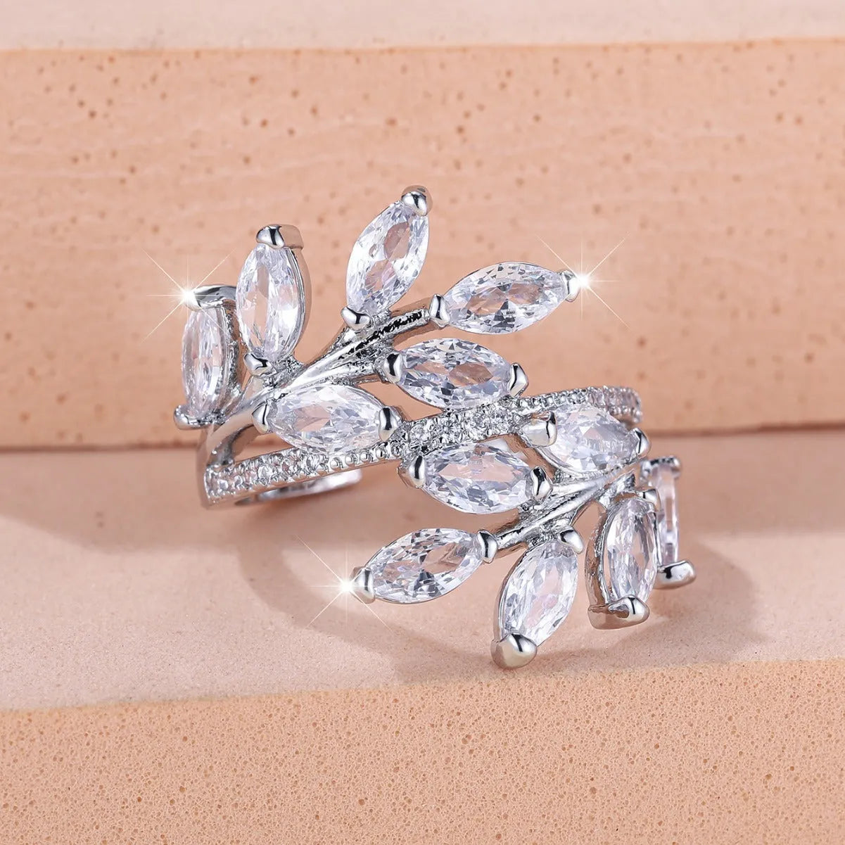 Copper leaf-shaped ring with adjustable band and central horse eye zircon stone in a choice of colours.