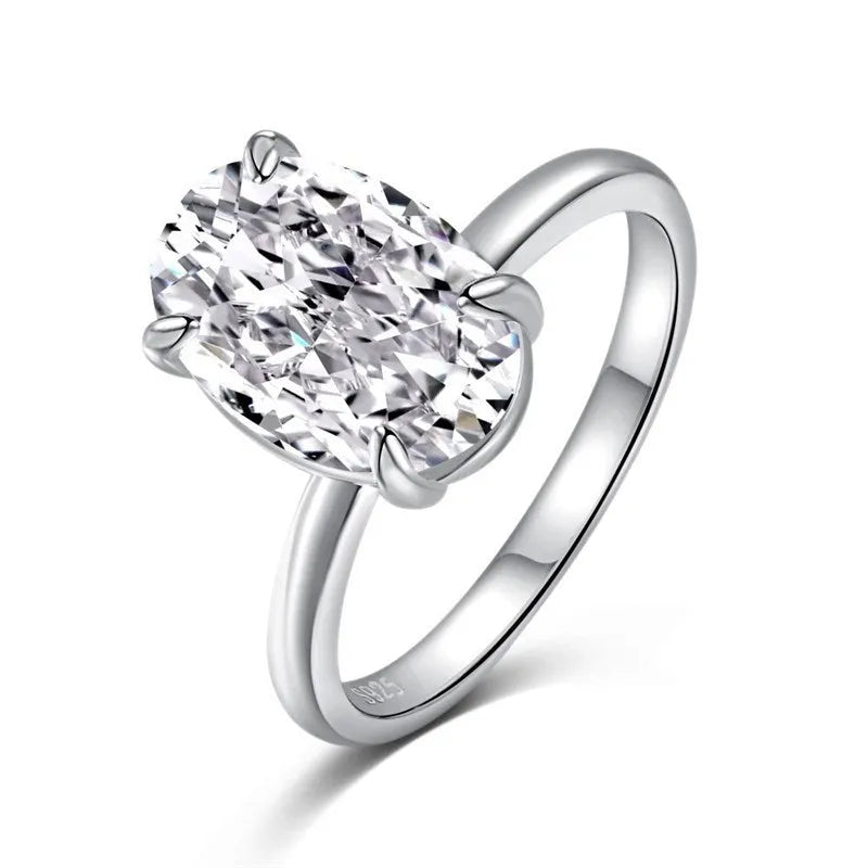 Oval sterling silver women's ring with four-claw setting and hand-cut gemstone.