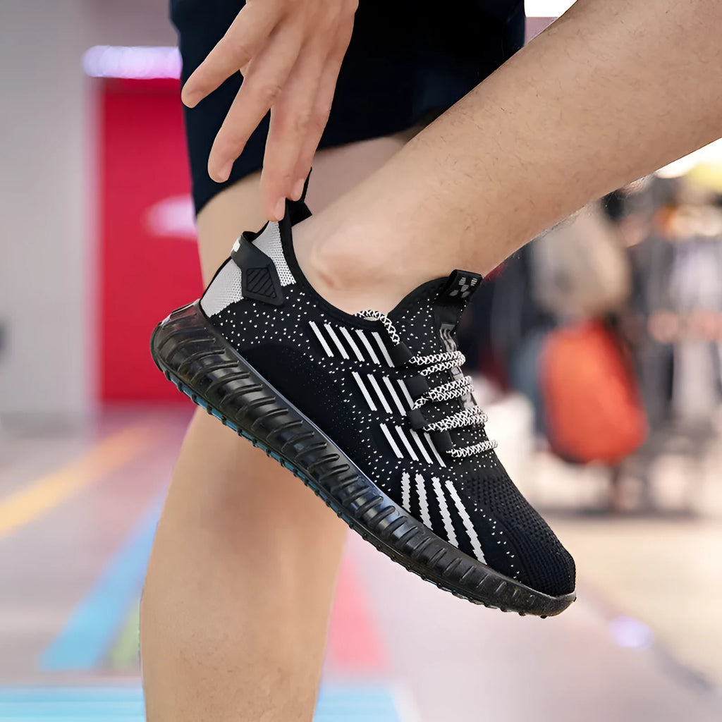 Men's breathable flying fabric sports shoes in black, shown with a flat platform heel and round toe design.