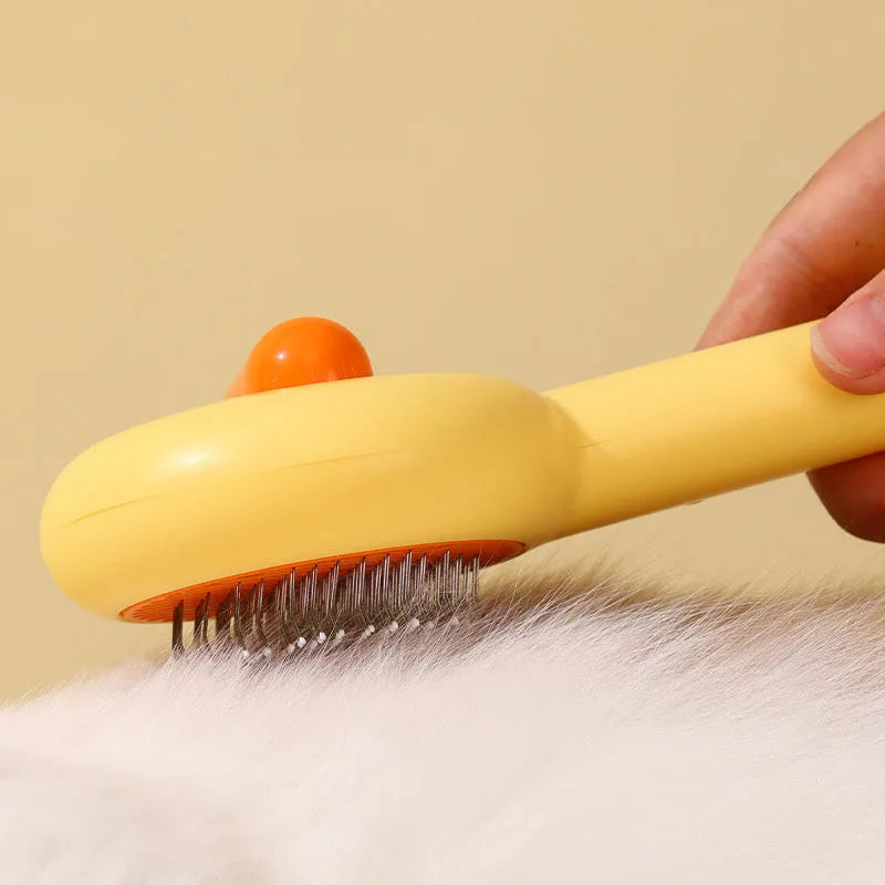 Small yellow duck-shaped pet comb with needle bristles for cat and dog grooming