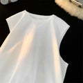 Men's loose fit cotton sleeveless t-shirt in a solid colour, shown on a hanger.