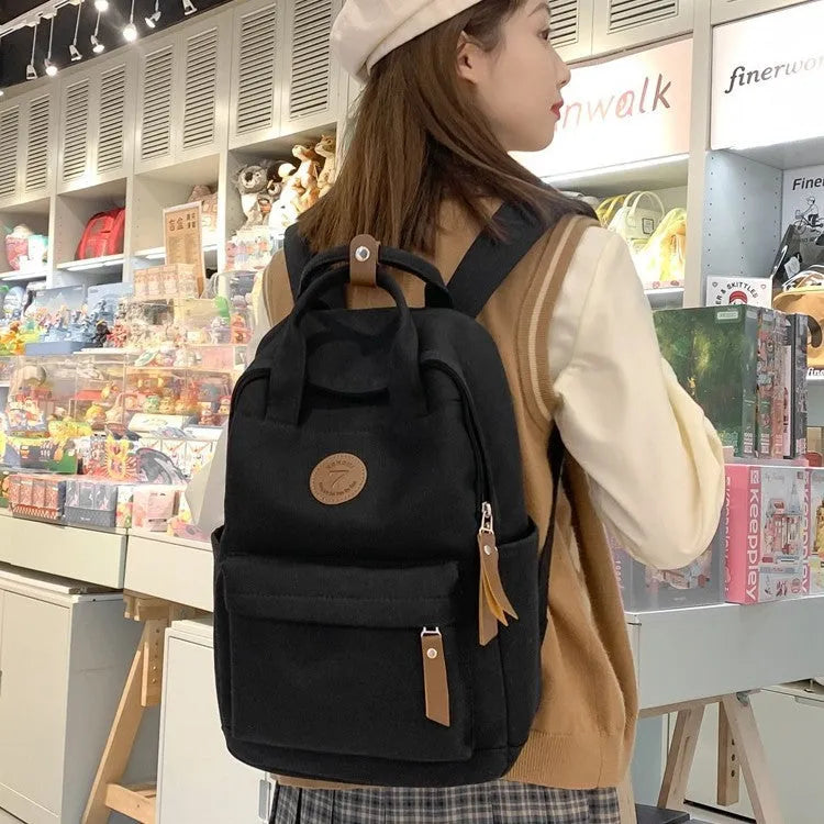 Black Oxford cloth backpack with curved shoulder straps for school and travel