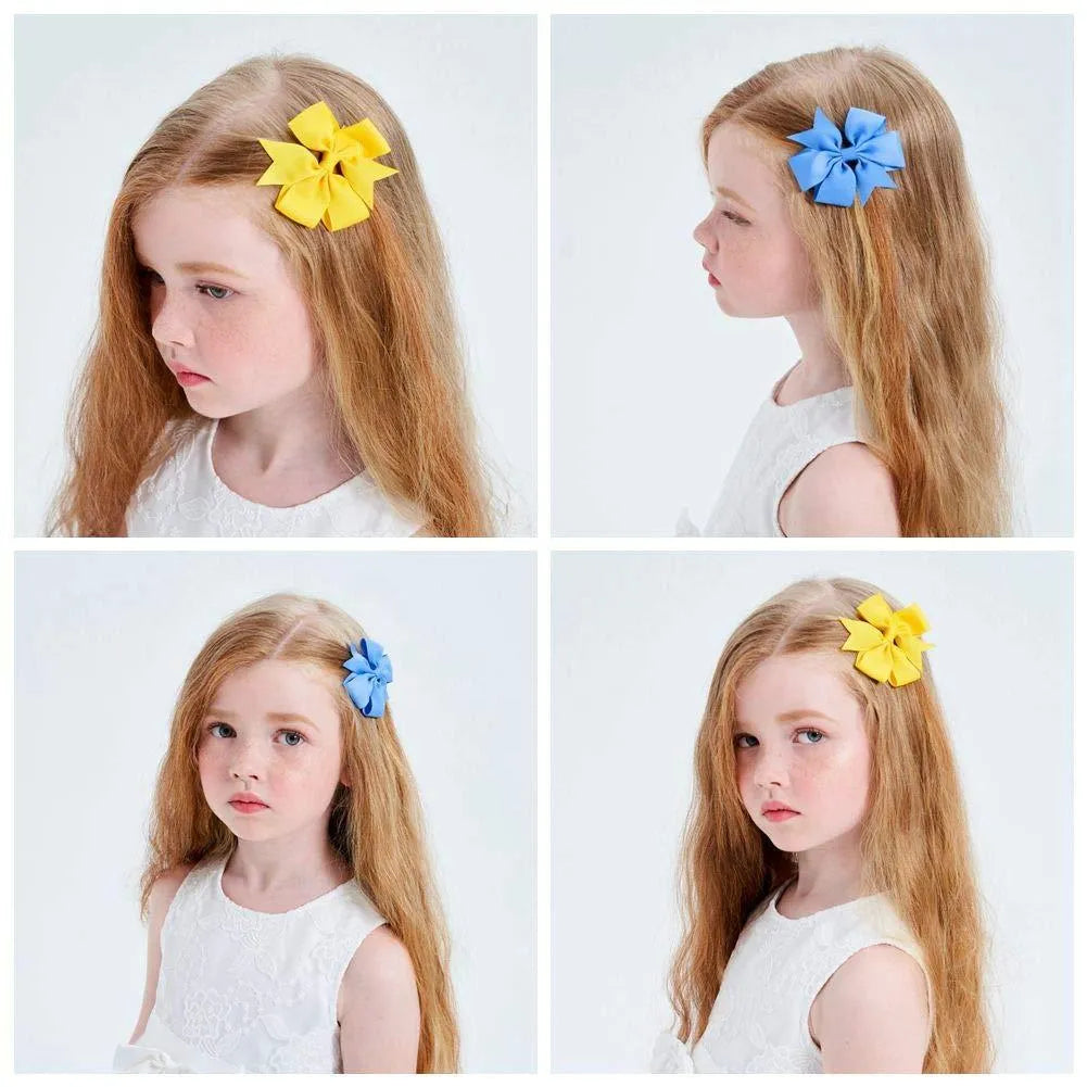 Assortment of colourful 3-inch grosgrain ribbon pinwheel hair bows with alligator clips for toddlers.