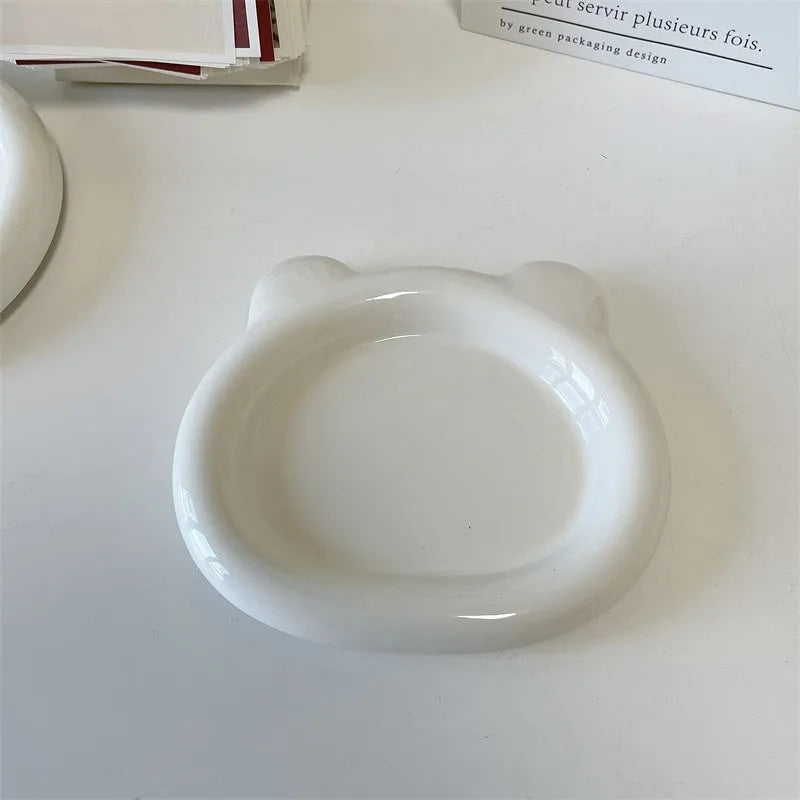 White porcelain plate with cute bear doodle design, 20cm size, on a table.