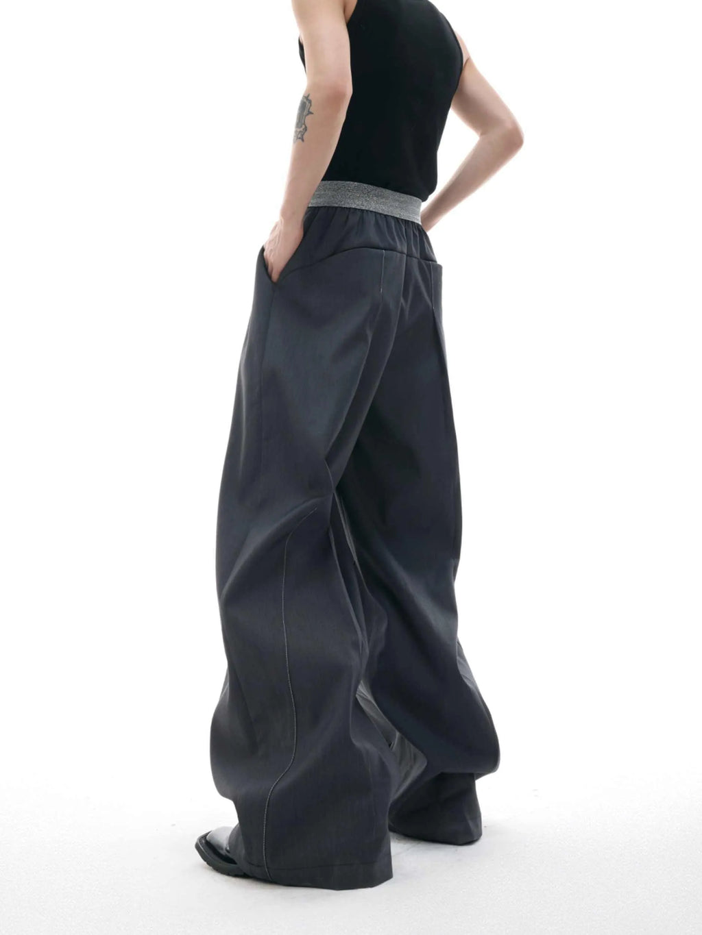 Man's black high-waisted straight-leg casual trousers with a button fly.