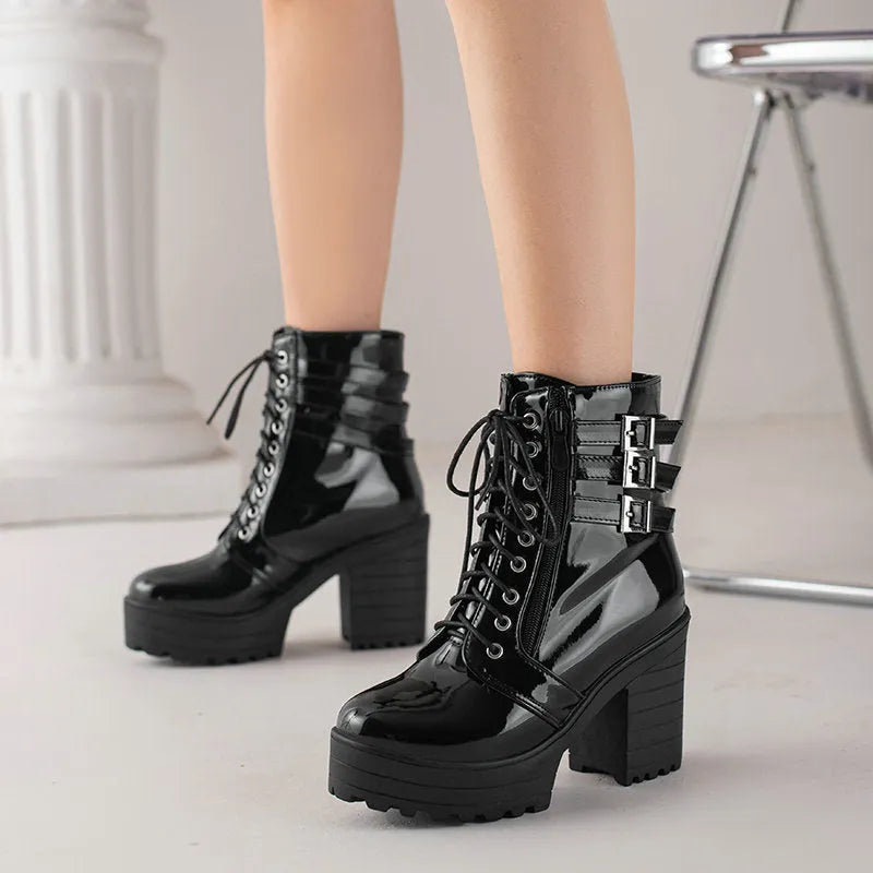 Women's black thick-heel short boots with front lace-up and round toe on a waterproof rubber sole.