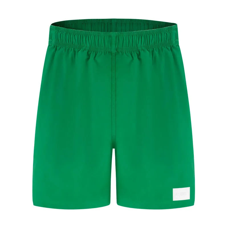 Men's solid colour quick-drying nylon sports shorts on a hanger, showing straight leg design