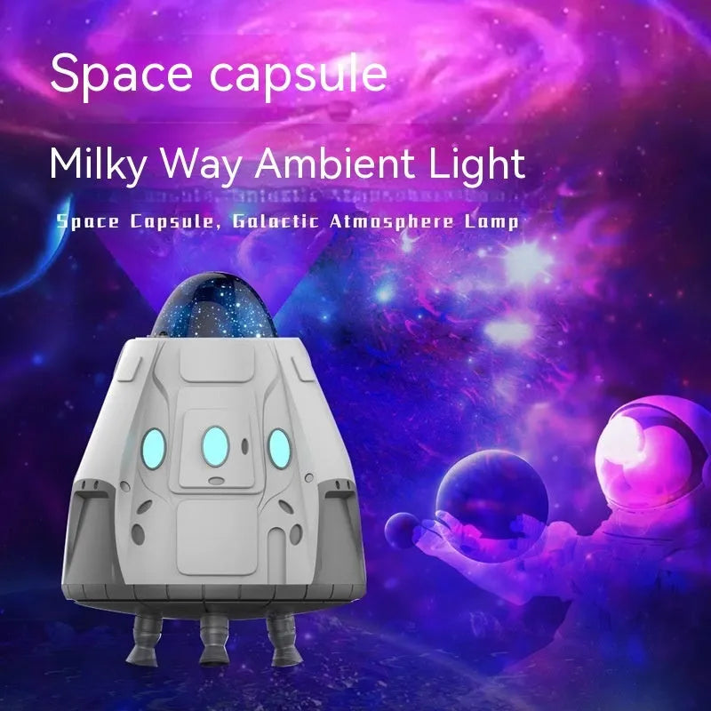 White space capsule Bluetooth ambience light projecting green northern lights on a dark wall.
