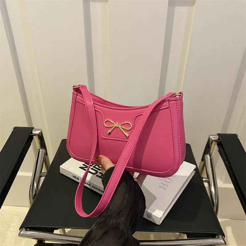 PU leather shoulder bag with bow detail in horizontal square shape showing rose red colour option