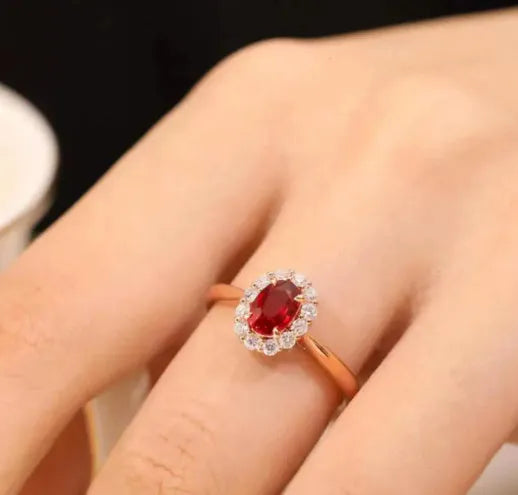 Sterling silver ring with gold pigeon design, floral pattern and red blood gemstone accents