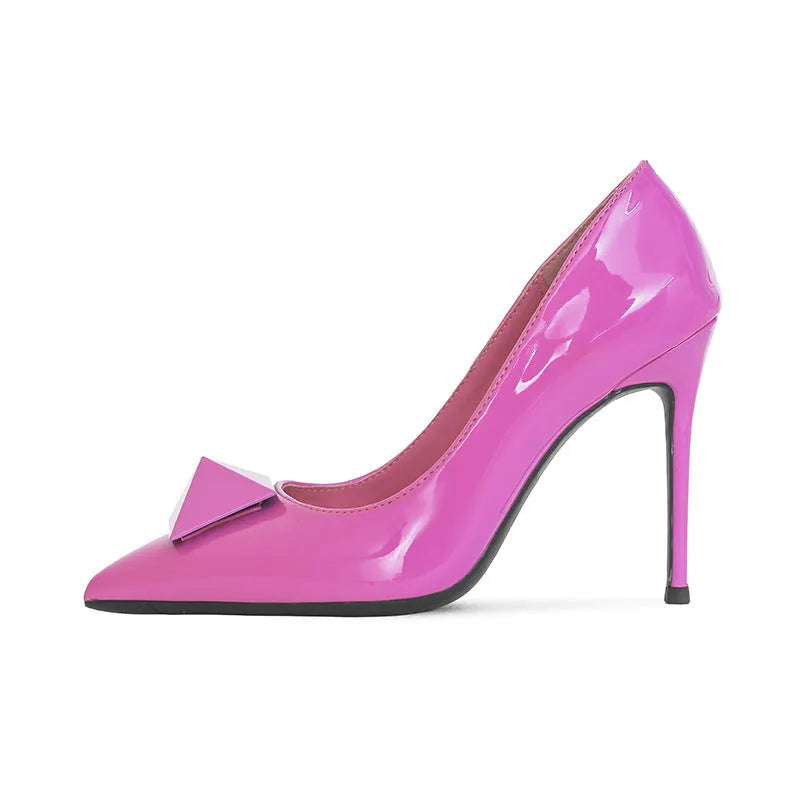Pink patent leather women's pointed toe stiletto heels with buckle and rivet details on a low-top ankle.