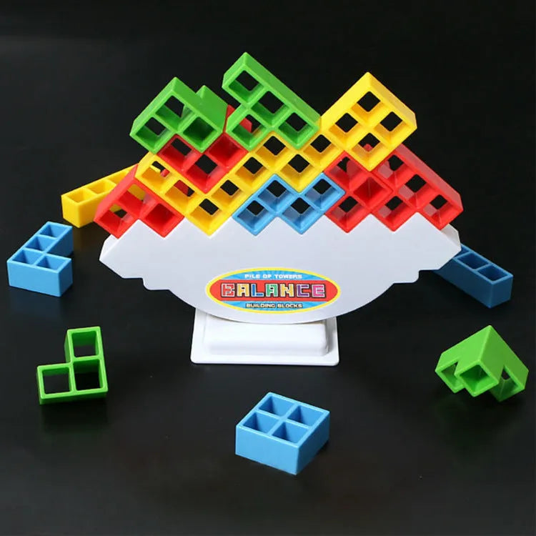 Plastic balance stacking game with 16 colourful building blocks, chassis and base on table