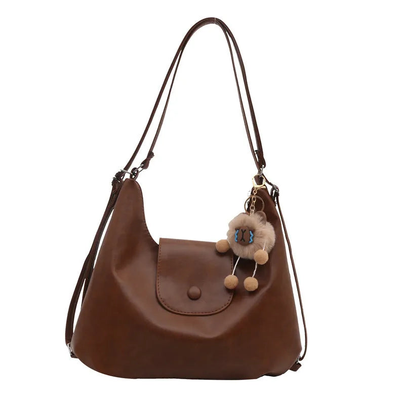 Leather women's shoulder bag in brown colour with single strap and structured horizontal design
