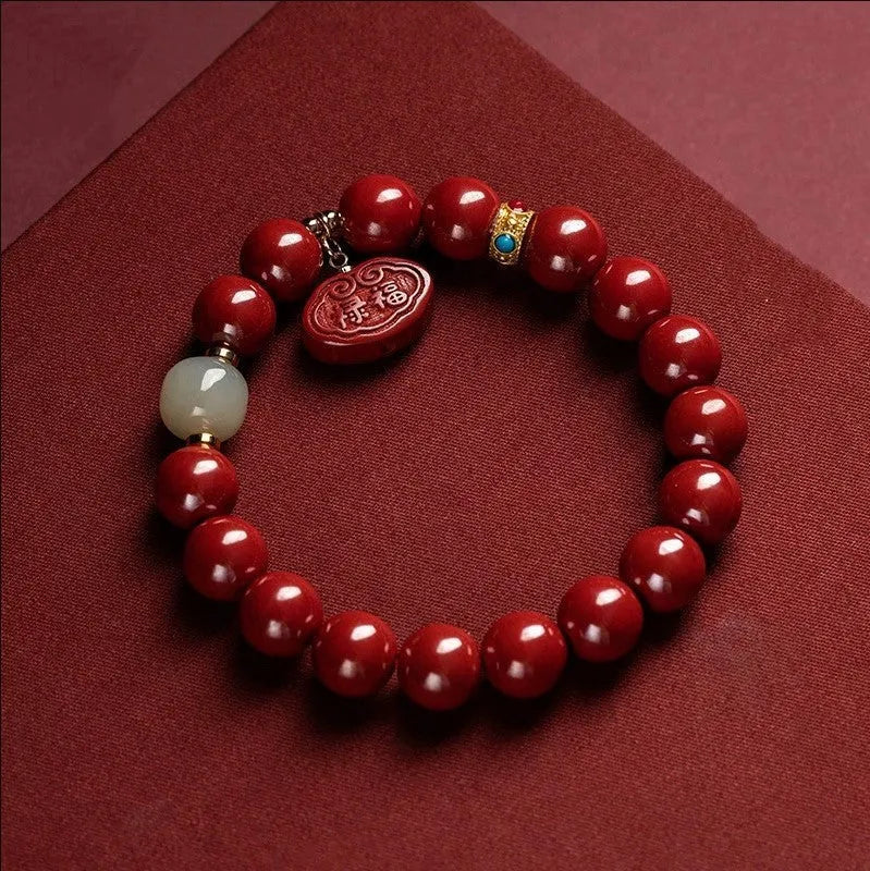Natural cinnabar Emperor Sandstone Ping An Fu Lu bracelet with red beads.