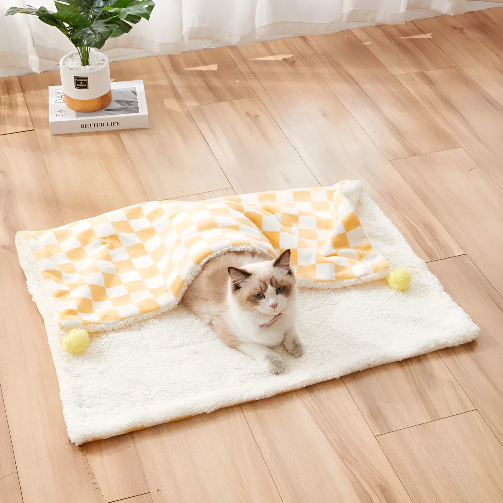 Green plush pet blanket with plaid pattern and fur balls as dog bed mat on sofa
