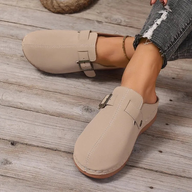 Women's casual wedge slippers in black with closed toe and rubber sole, shown from the side.