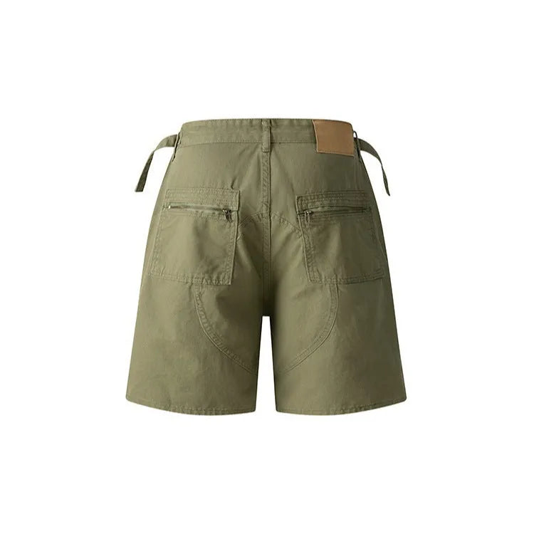 A pair of grey loose-fit cotton workwear shorts with a half-elastic waistband and side zipper on a neutral background.