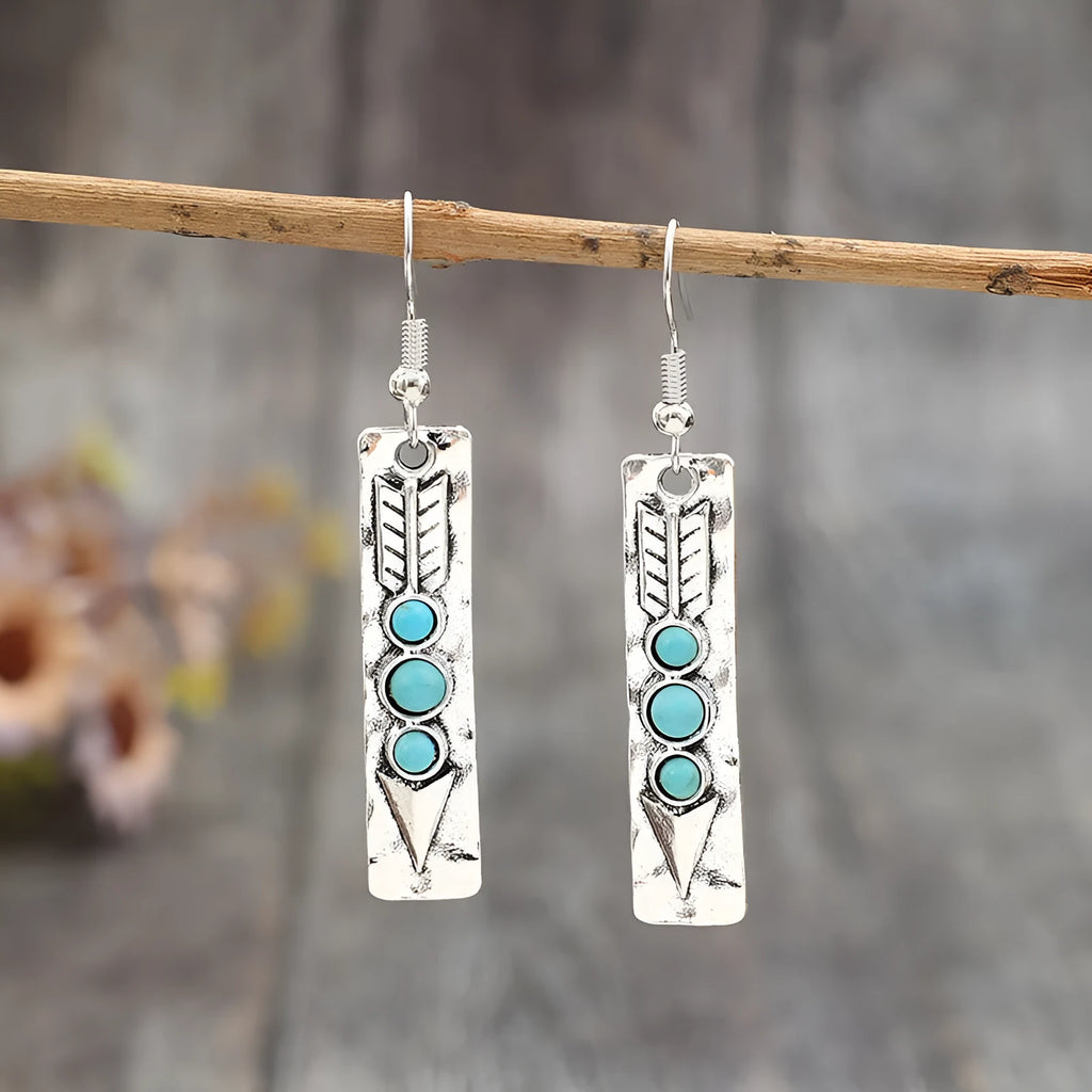 Long silver geometric earrings with turquoise inlay details on zinc alloy