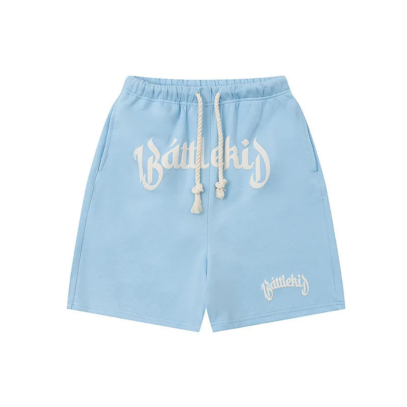 Men's loose cotton blend cropped shorts in grey, shown in a casual setting