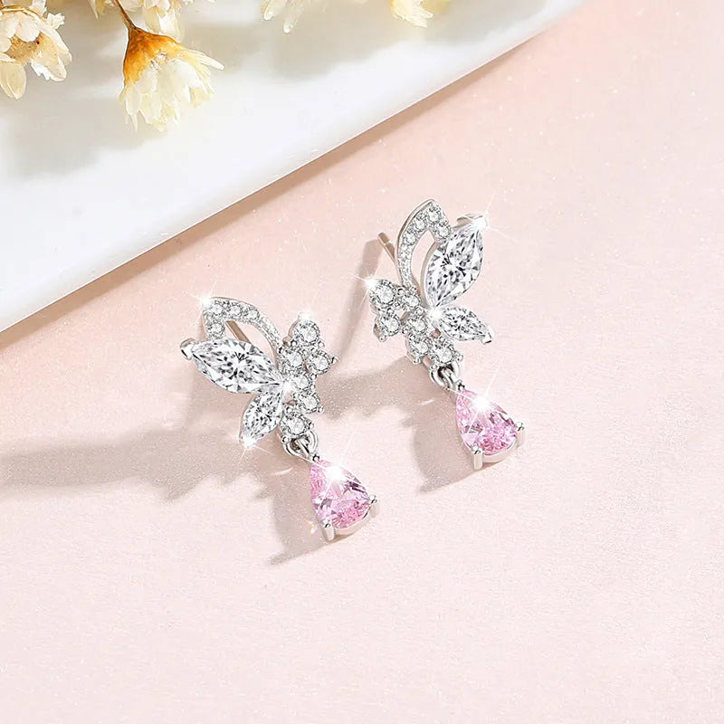 Sterling silver butterfly stud earrings with crystal details on woman's earlobe