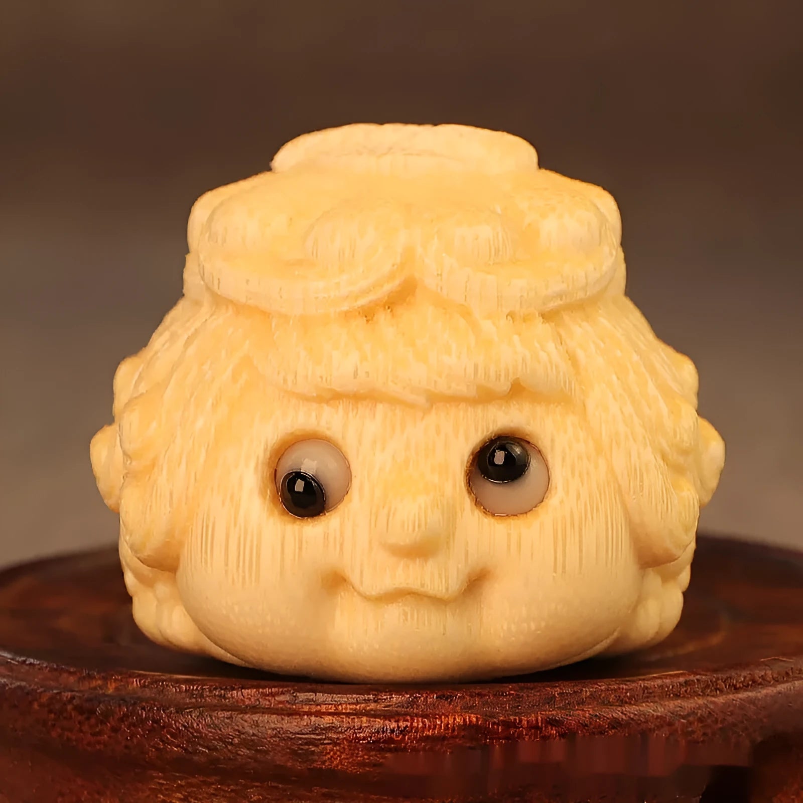 Solid bamboo carved golden toad princess ornament on display.