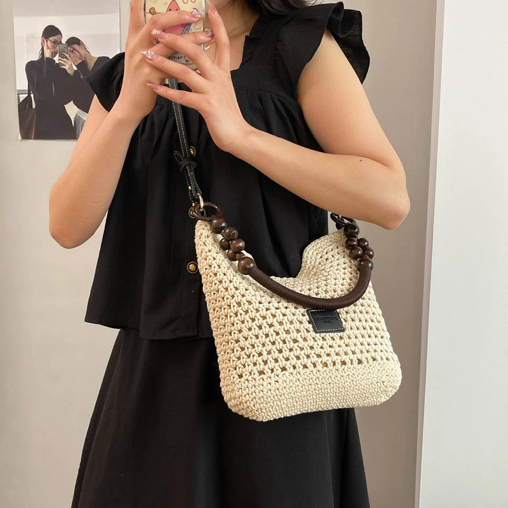 Knitted bucket tote beach bag with contrast stitching and zippered interior compartment