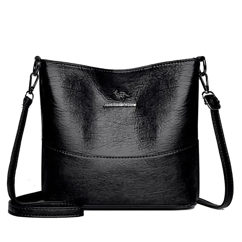 Women's black soft leather bucket-style shoulder bag with minimalist design and visible stitching