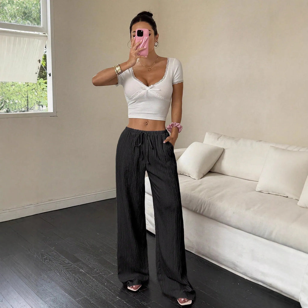 Women's black wide leg trousers with lace-up waist trimming detail on mid-waist