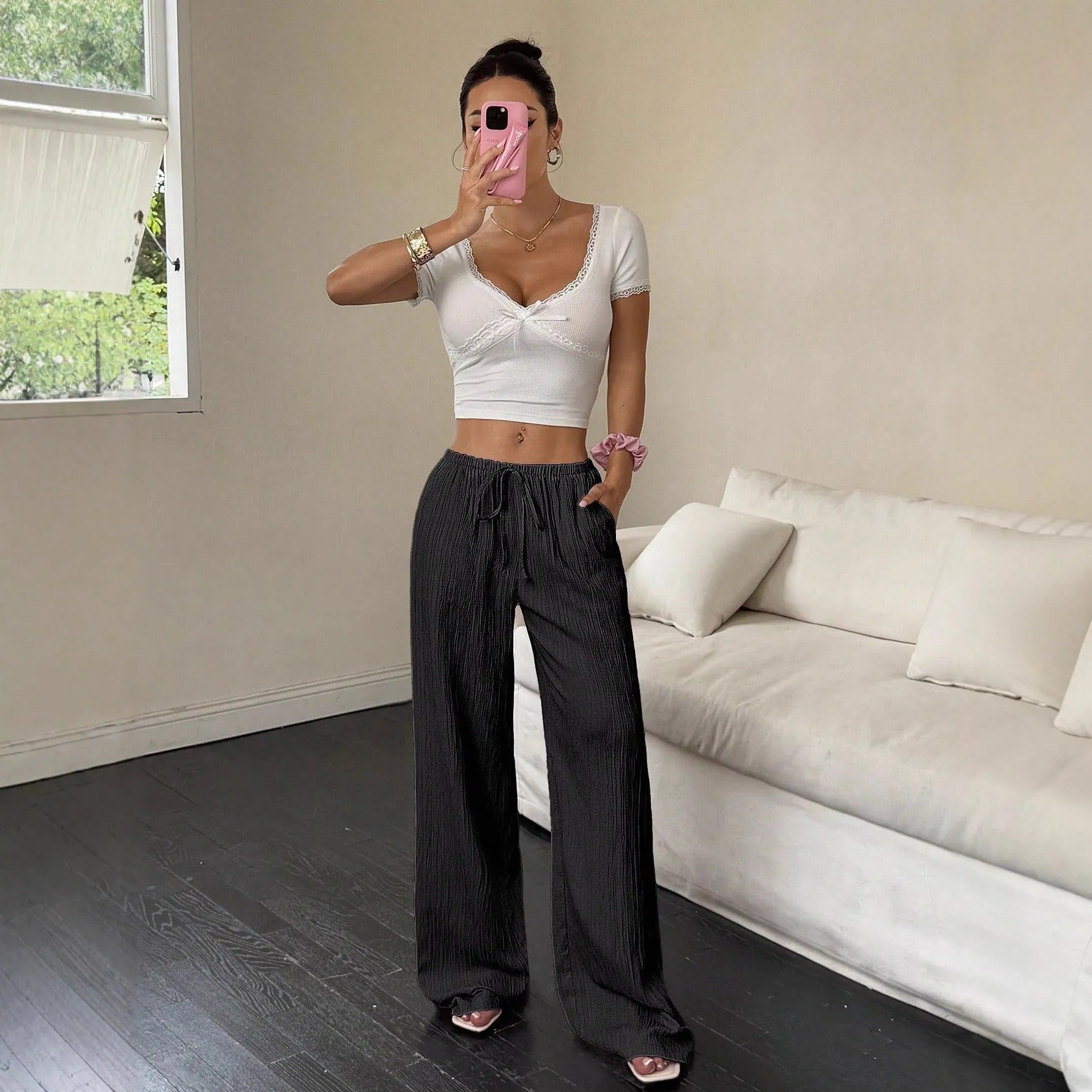 Women's black wide leg trousers with lace-up waist trimming detail on mid-waist