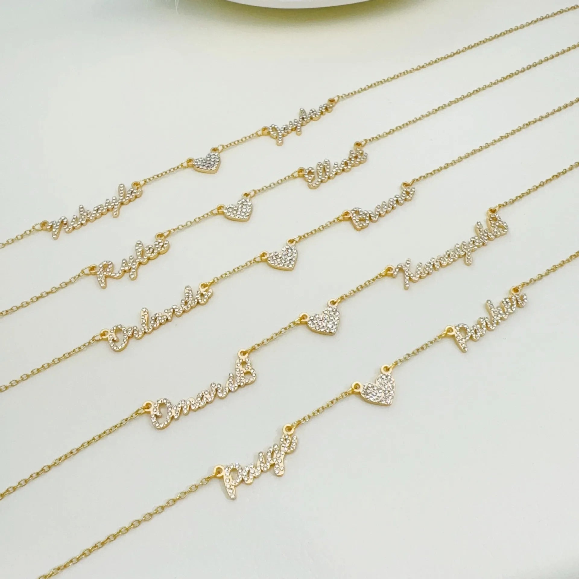 Customised diamond inlaid multi name necklace on stainless steel O-shaped chain, gold finish, with heart charms