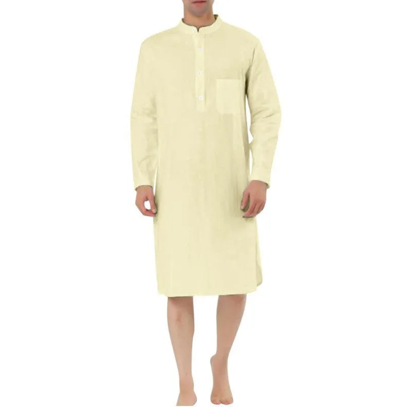 Man wearing a dark blue cotton shirt robe with a button front and chest pocket.