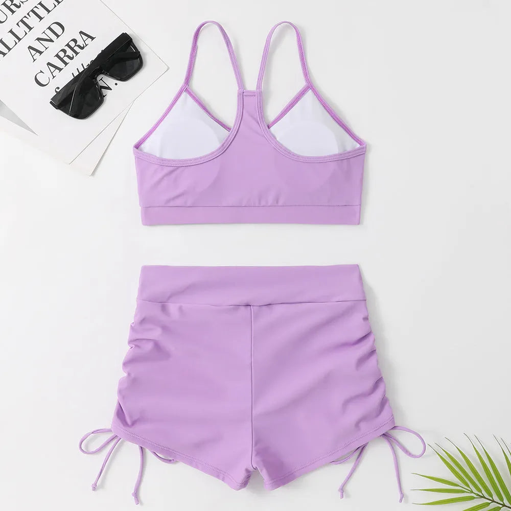 Women's high waist split swimsuit bikini in black or violet colours for swimming activities