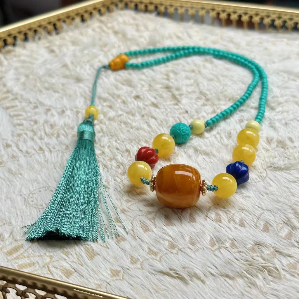 Turquoise lucky pendant necklace with hand-woven mesh flower design on adjustable ball bead chain