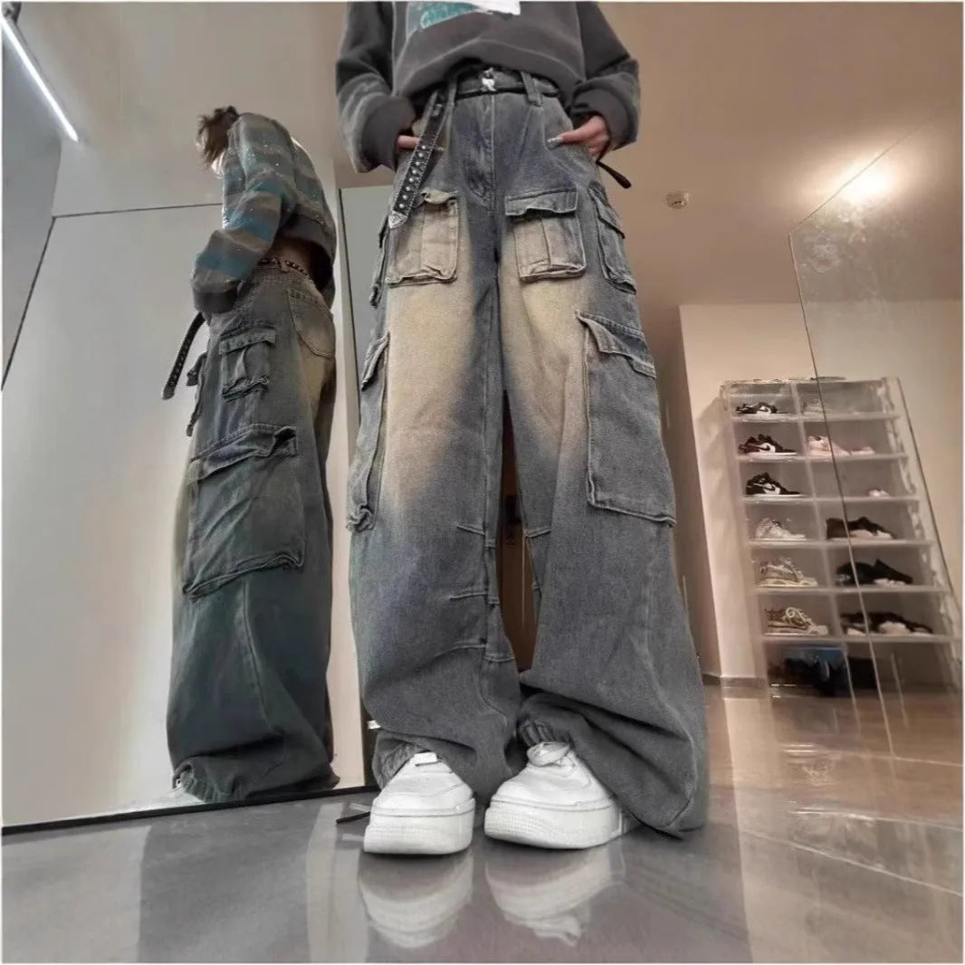 Light blue and black loose fit distressed denim pants with multiple tooling-style pockets